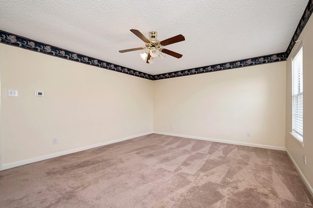 carpeted empty room featuring a textured ceiling and ceiling fan