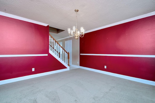 unfurnished room featuring carpet, ornamental molding, a textured ceiling, and a notable chandelier