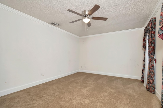 carpeted empty room featuring ceiling fan, crown molding, and a textured ceiling