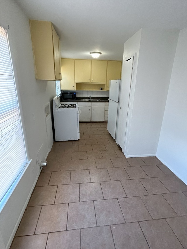 kitchen featuring white appliances and sink