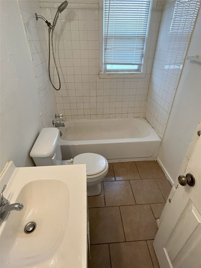 full bathroom with tiled shower / bath combo, tile patterned floors, vanity, and toilet