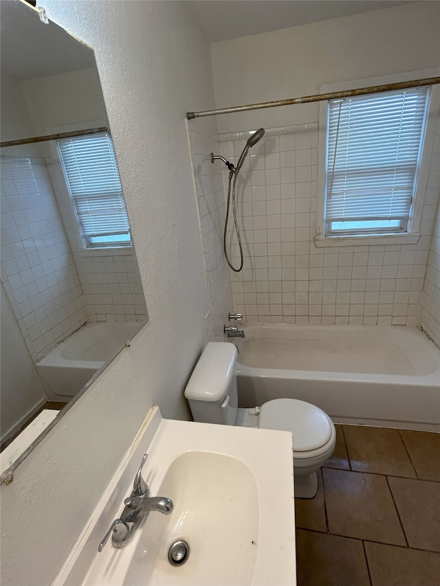 full bathroom featuring tile patterned floors, vanity, toilet, and tiled shower / bath