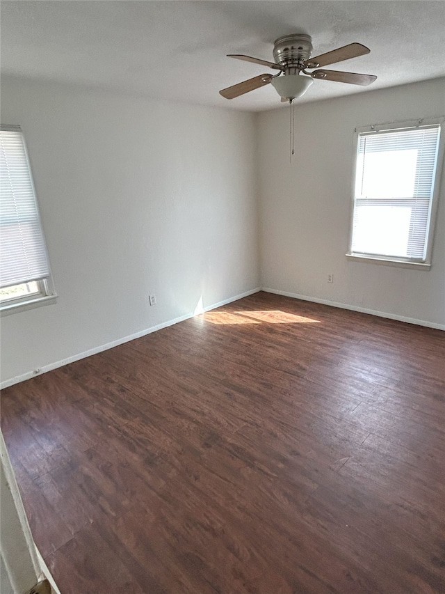 empty room featuring ceiling fan and dark hardwood / wood-style floors