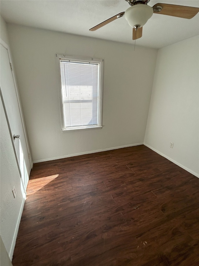 empty room featuring ceiling fan and dark wood-type flooring