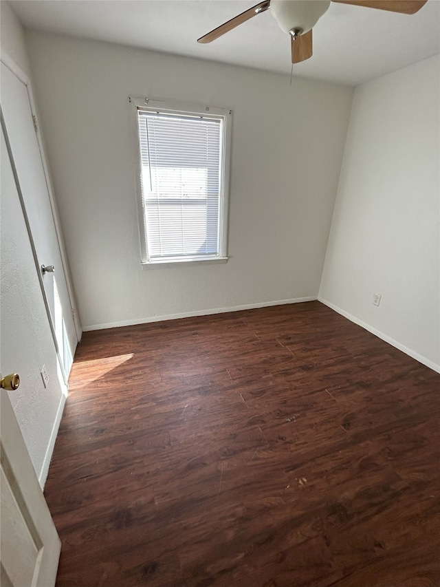 empty room featuring ceiling fan and dark wood-type flooring