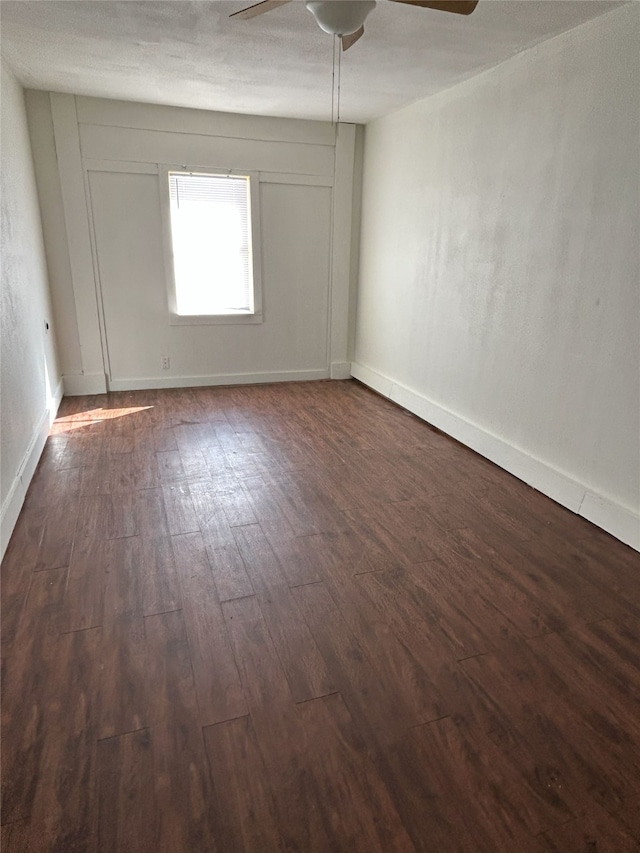 unfurnished room with ceiling fan and dark hardwood / wood-style floors