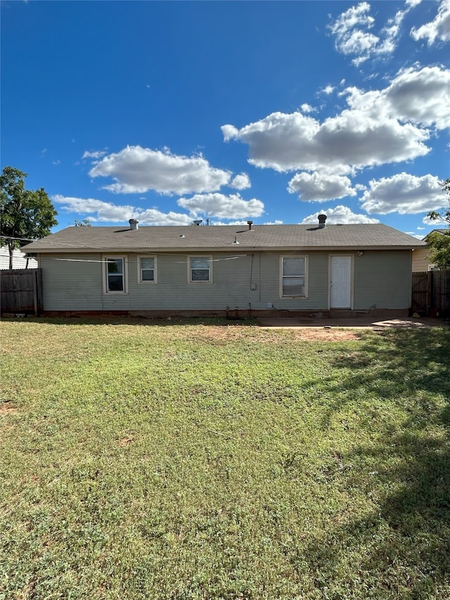 back of house with a lawn