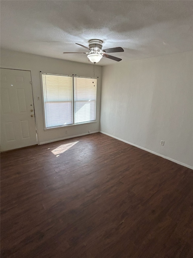 unfurnished room featuring a textured ceiling, ceiling fan, and dark hardwood / wood-style flooring