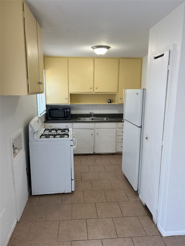 kitchen with backsplash, sink, and white appliances