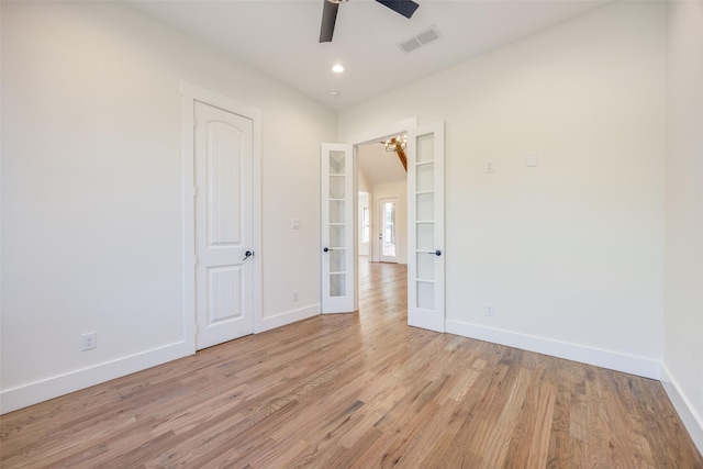 unfurnished room with french doors, light wood-type flooring, and ceiling fan