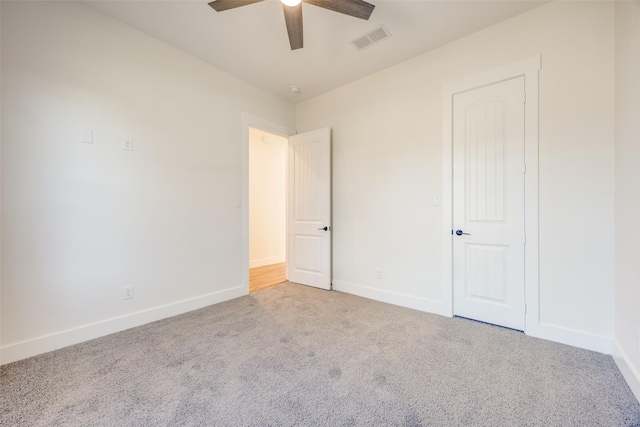 unfurnished bedroom with ceiling fan and light colored carpet