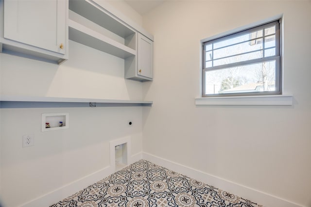 clothes washing area featuring electric dryer hookup, light tile patterned flooring, cabinets, and hookup for a washing machine