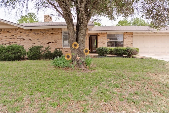 ranch-style home featuring a front yard and a garage