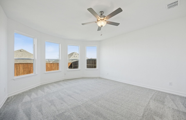 carpeted spare room featuring ceiling fan