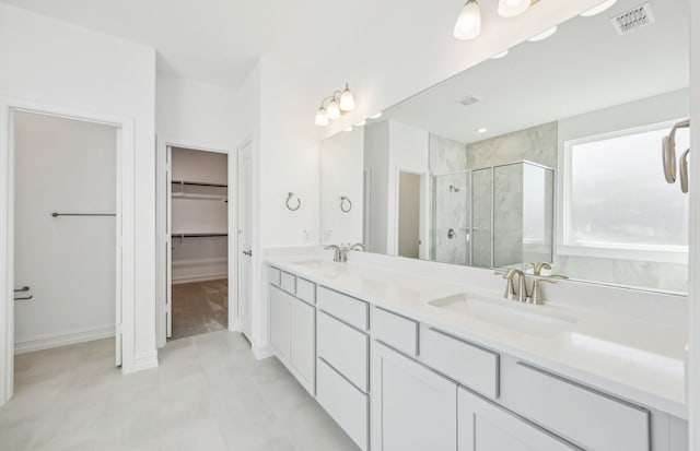 bathroom with tile patterned floors, vanity, and a shower with shower door