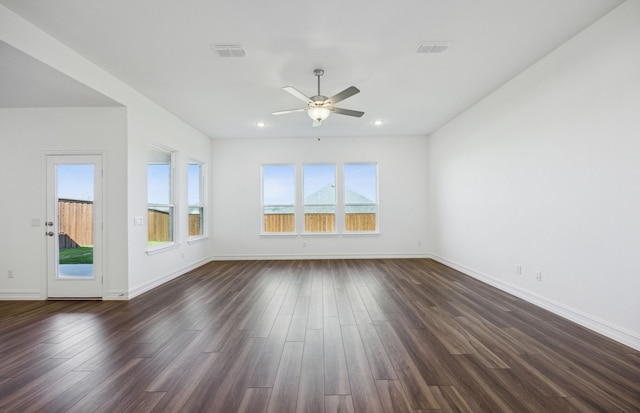 empty room with ceiling fan and dark wood-type flooring