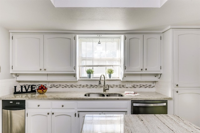 kitchen featuring white cabinetry, stainless steel dishwasher, tasteful backsplash, and sink