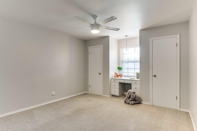 unfurnished bedroom featuring ceiling fan and light carpet