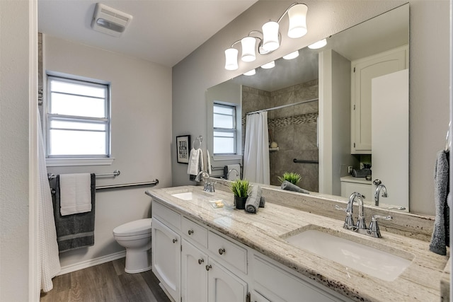 bathroom with hardwood / wood-style floors, vanity, toilet, and a shower with shower curtain