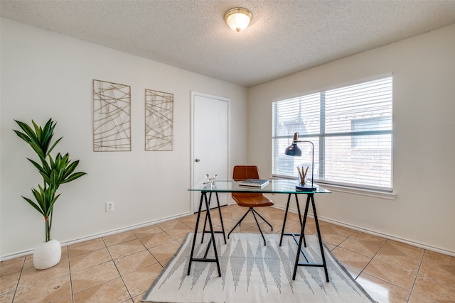 office area featuring light tile patterned floors and a textured ceiling