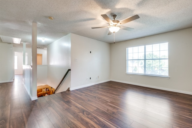 unfurnished room featuring a textured ceiling, dark hardwood / wood-style flooring, and ceiling fan