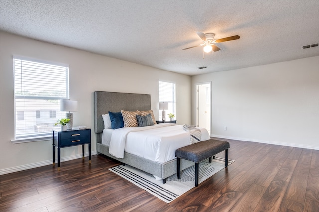 bedroom with dark hardwood / wood-style flooring, multiple windows, and ceiling fan