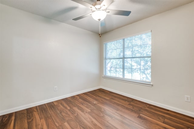 empty room featuring ceiling fan and dark wood-type flooring