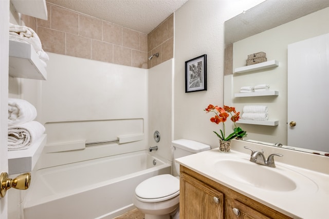 full bathroom featuring vanity, toilet, a textured ceiling, and tiled shower / bath