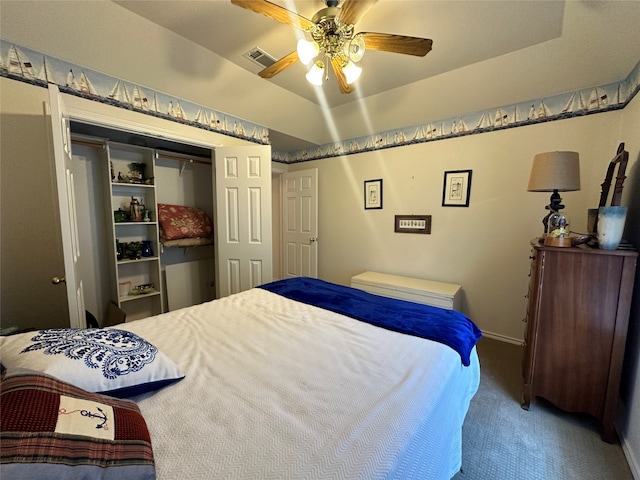 bedroom with lofted ceiling, a closet, carpet flooring, and ceiling fan