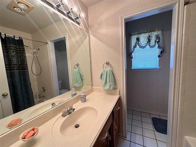 full bath with shower / tub combo with curtain, toilet, tile patterned flooring, and vanity