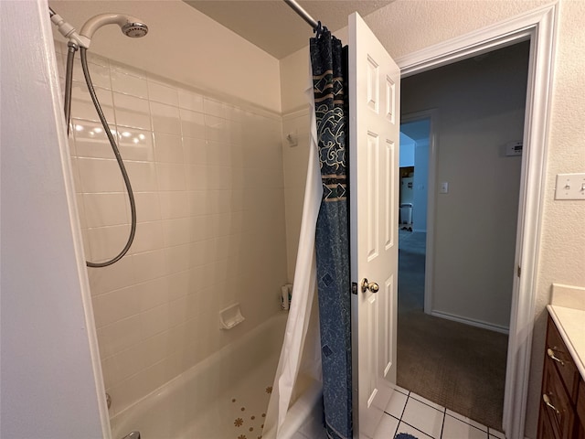 bathroom with tile patterned flooring, a textured ceiling, vanity, and shower / bath combination with curtain