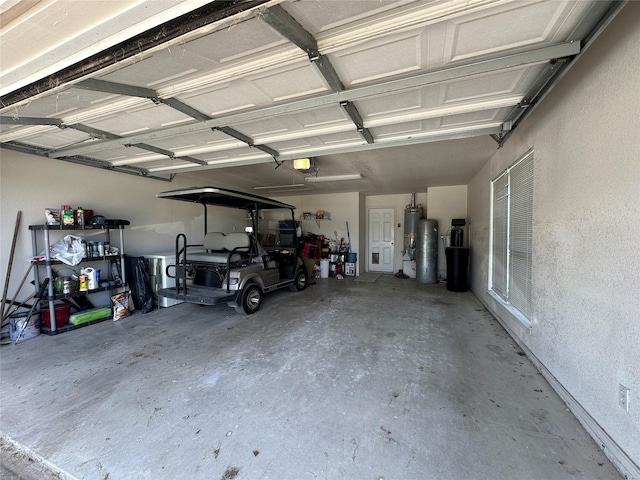garage featuring water heater and a textured wall