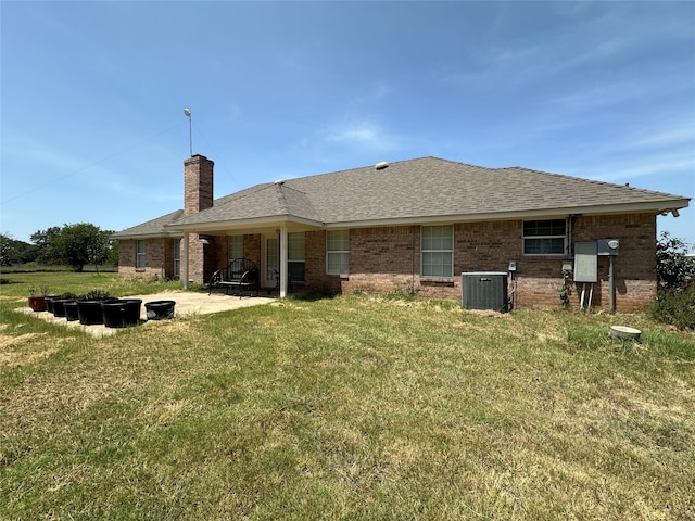 back of property featuring a lawn, a patio area, and central AC