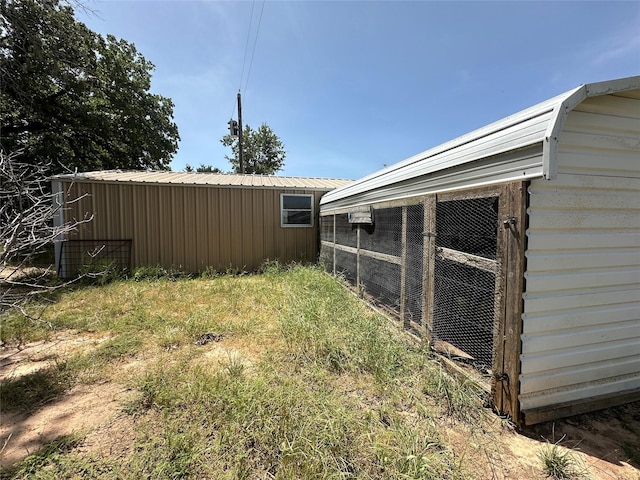 view of yard featuring exterior structure and an outbuilding