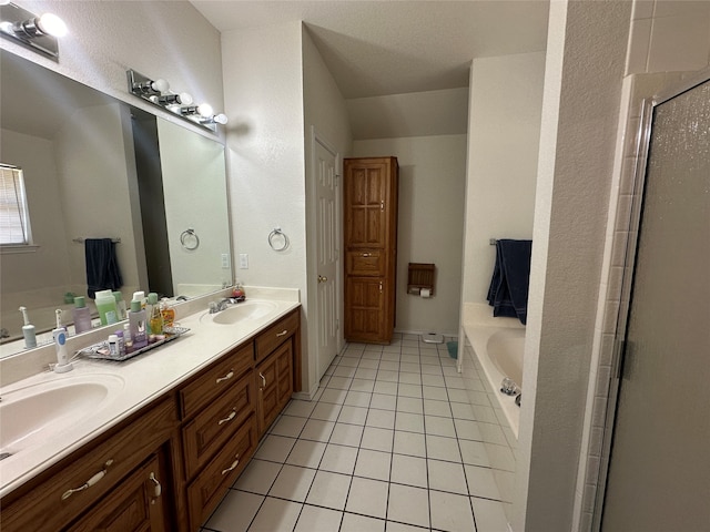 bathroom with tile patterned floors, vanity, and independent shower and bath