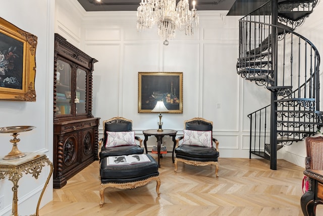 living area featuring crown molding, a chandelier, and light parquet flooring