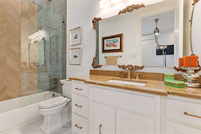 full bathroom with vanity, bath / shower combo with glass door, and toilet