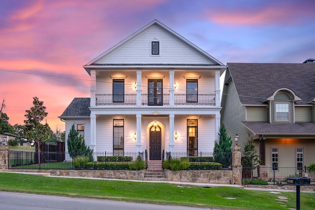 view of front of property featuring a porch and a balcony