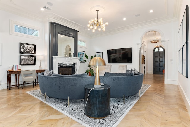 living room featuring a towering ceiling, parquet floors, a high end fireplace, crown molding, and a notable chandelier