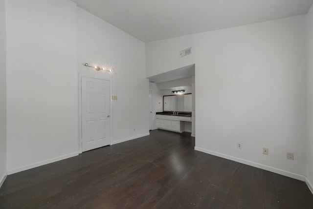 unfurnished living room featuring dark hardwood / wood-style floors