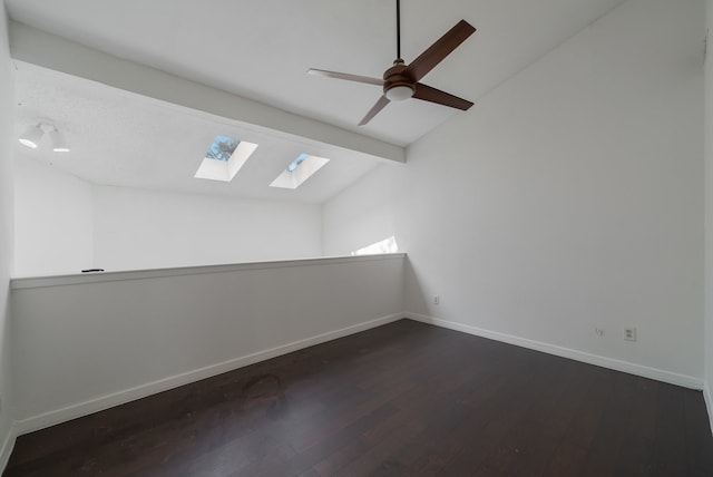 empty room with ceiling fan, dark wood-type flooring, and vaulted ceiling