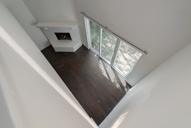 stairway featuring wood-type flooring and a towering ceiling