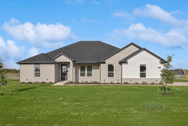 rear view of property with a yard