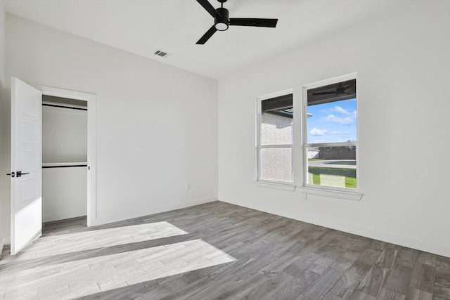 unfurnished bedroom featuring ceiling fan, light hardwood / wood-style flooring, and a closet