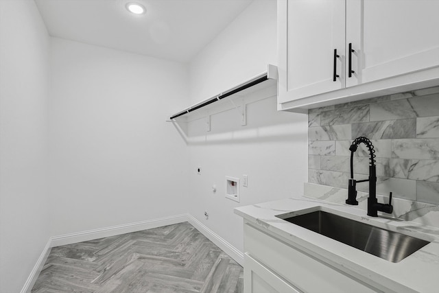 washroom featuring hookup for an electric dryer, sink, washer hookup, gas dryer hookup, and cabinets