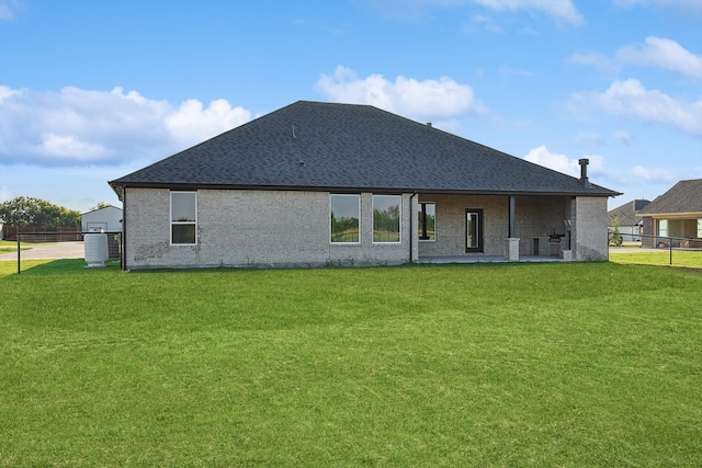 back of house featuring a yard and a patio