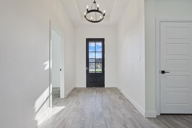 entrance foyer with a chandelier and light hardwood / wood-style flooring