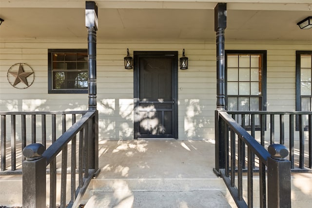 view of exterior entry featuring a porch