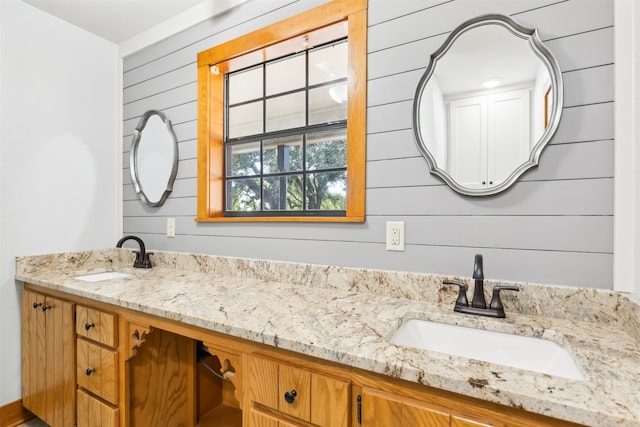 bathroom with wood walls and vanity