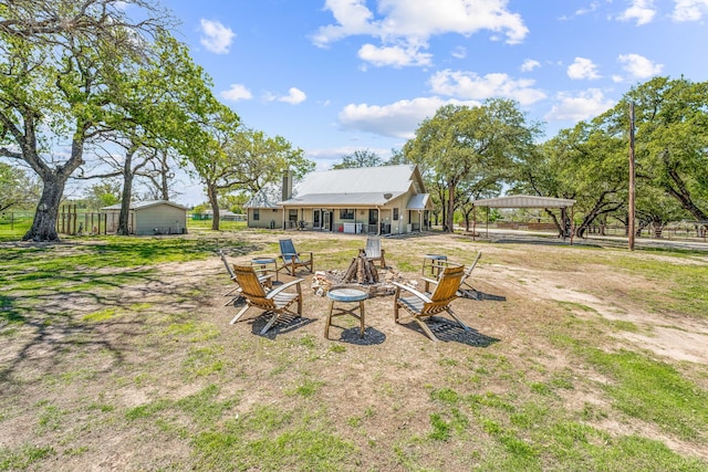 view of yard featuring an outdoor fire pit and a gazebo